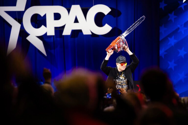 Musk gets big cheers — and a chainsaw — at CPAC