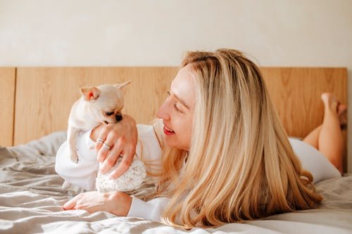 Why Does My Dog Nibble On Me? It's Canine For "I Love You," Actually