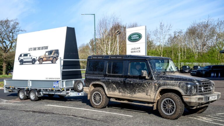 Land Rover Trolled In Public By A Muddy SUV And A Rolling Billboard