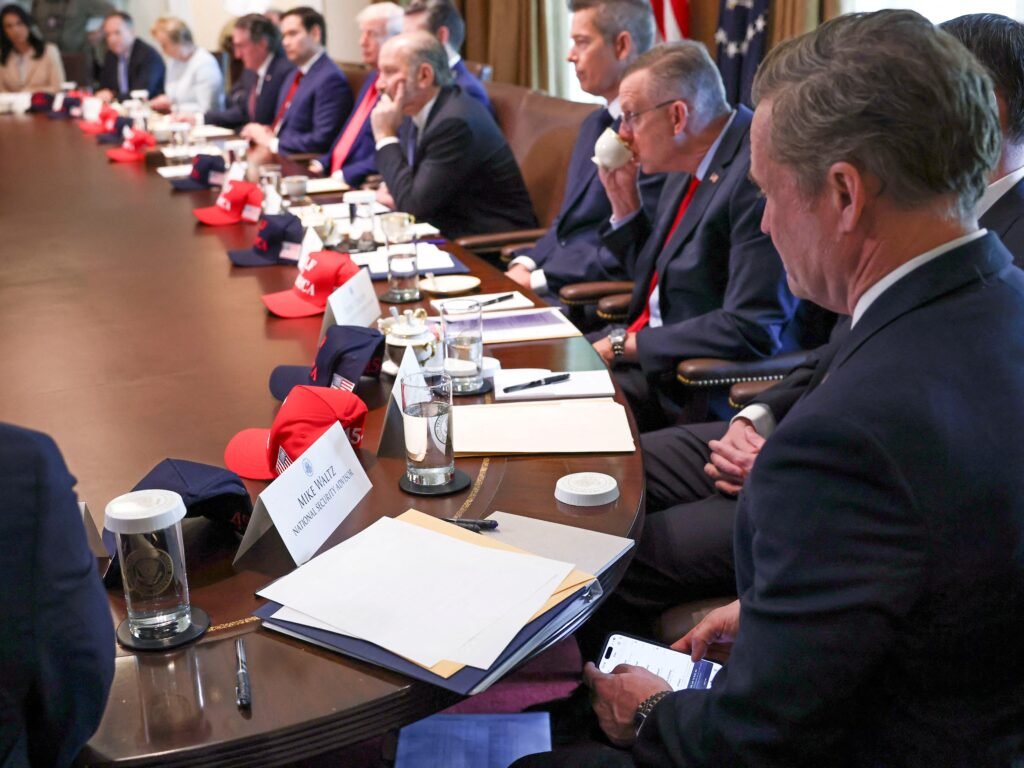 Photo appears to show now-former national security advisor Mike Waltz checking Signal during a Cabinet meeting