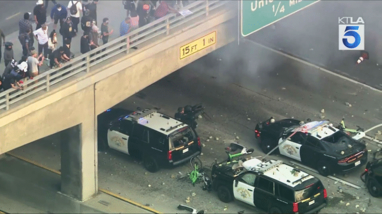 Video: Protesters throw rocks at CHP officers from LA freeway bridge
