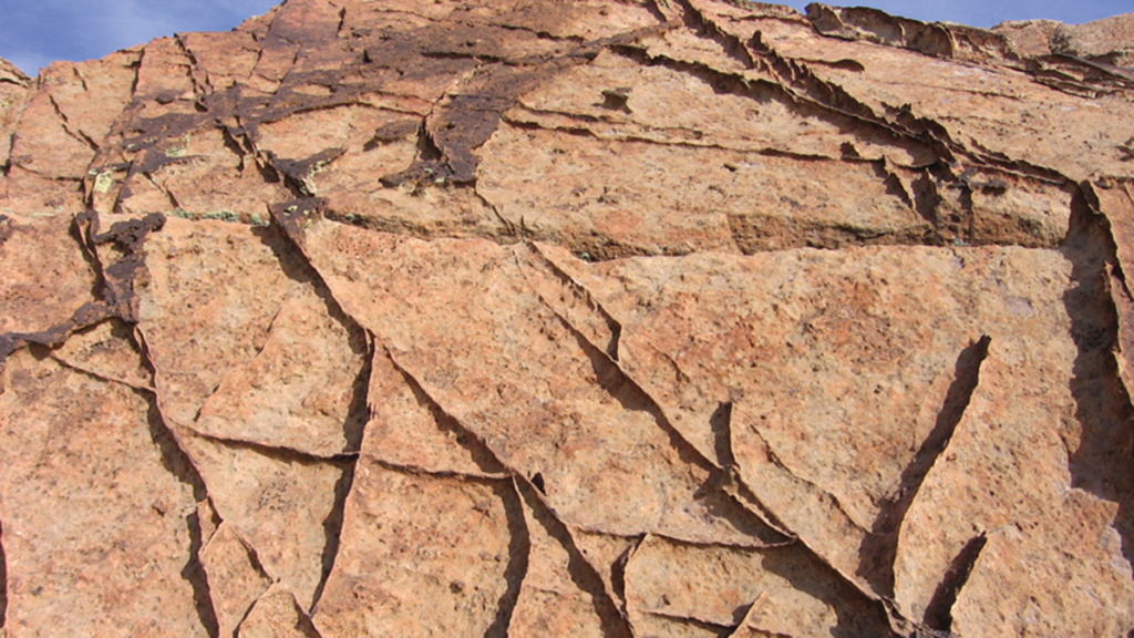 From Grains to Bands: Modeling Deformation in Porous Rocks