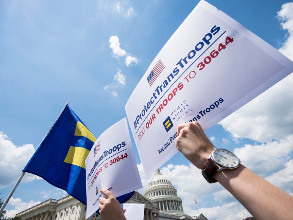 Transgender US troops can continue serving for now, in a major reversal for Trump