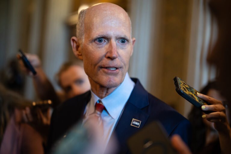 Rick Scott says he’s just trying to help